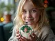 thumbnail child holds christmas ornament of herself